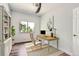Bright office space with natural light, a wooden desk, and an elegant bookshelf at 1793 E 164Th Pl, Thornton, CO 80602