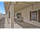 Covered back porch with tile floor and two chairs at 5688 Alcott St, Denver, CO 80221