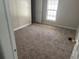 View of bedroom with wall-to-wall carpeting, a window, and a closet at 5688 Alcott St, Denver, CO 80221