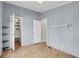 Bedroom featuring tile floor, open closets, and neutral walls with shelving at 5688 Alcott St, Denver, CO 80221
