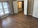 View of bedroom with hardwood flooring, large window and several closets at 5688 Alcott St, Denver, CO 80221