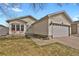 Charming single-story home featuring a two-car garage, a well-maintained lawn and a cozy front porch at 5688 Alcott St, Denver, CO 80221