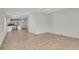 Open-concept living room featuring ceramic tile flooring and access to a modern, updated kitchen at 5688 Alcott St, Denver, CO 80221