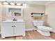 Compact bathroom featuring vanity, mirror, and toilet, with wood-look flooring at 2074 Oakcrest Cir, Castle Rock, CO 80104