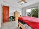 Charming bedroom with a ceiling fan, good window view, wooden door, carpeted floors, and closet at 2074 Oakcrest Cir, Castle Rock, CO 80104