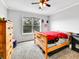Bright bedroom featuring a ceiling fan, a window providing a backyard view, and carpeted floors at 2074 Oakcrest Cir, Castle Rock, CO 80104