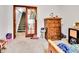 Cozy bedroom featuring a wooden dresser, an open closet, and carpeted floors at 2074 Oakcrest Cir, Castle Rock, CO 80104