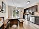 Bright kitchen with stainless steel appliances and rustic dining table set at 2074 Oakcrest Cir, Castle Rock, CO 80104