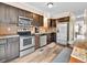 Modern kitchen with stainless steel appliances, dark wood cabinets, and tile backsplash at 2074 Oakcrest Cir, Castle Rock, CO 80104