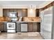 Well-equipped kitchen features stainless steel appliances and dark wood cabinets at 2074 Oakcrest Cir, Castle Rock, CO 80104