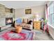 Cozy living room with stone fireplace, leather sofa, and wood-look floors at 2074 Oakcrest Cir, Castle Rock, CO 80104