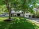 Spacious backyard with mature trees, a covered patio, and a well-manicured lawn provides ample space for outdoor activities at 4071 S Dahlia St, Cherry Hills Village, CO 80113