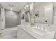 Bathroom featuring a double vanity with white marble countertops and a tub/shower with gray tile surround at 4071 S Dahlia St, Cherry Hills Village, CO 80113