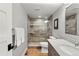 Modern bathroom featuring a glass walk-in shower, wood-look flooring, and a marble vanity top at 4071 S Dahlia St, Cherry Hills Village, CO 80113