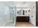 Bright bathroom showcasing a glass-enclosed shower, marble countertops, modern fixtures and light wood flooring at 4071 S Dahlia St, Cherry Hills Village, CO 80113