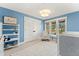 Cozy bedroom with a light blue walls, white trim and carpet and large window overlooking the yard at 4071 S Dahlia St, Cherry Hills Village, CO 80113