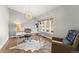 Bright home office featuring natural light from large windows, a modern desk, stylish decor, and hardwood floors at 4071 S Dahlia St, Cherry Hills Village, CO 80113