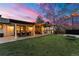 Exterior patio with a dining table, overhead lighting, and a grassy lawn with a swing at 4071 S Dahlia St, Cherry Hills Village, CO 80113