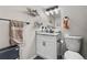 Well-lit bathroom featuring a white vanity with granite countertop, a toilet and modern fixtures at 850 Grove St, Denver, CO 80204