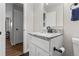 Well-lit bathroom featuring a modern vanity with granite countertop, a toilet and modern fixtures at 850 Grove St, Denver, CO 80204