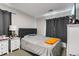 View of a bedroom with a bed, two nightstands, and window with dark curtains at 850 Grove St, Denver, CO 80204