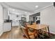 Open concept dining area adjacent to a modern kitchen with white cabinets and stainless steel appliances at 850 Grove St, Denver, CO 80204