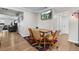 Cozy dining area with a wood table, rolling chairs, hardwood floors, and a view to the living room at 850 Grove St, Denver, CO 80204