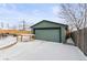 View of a detached garage with a table in front surrounded by snow at 850 Grove St, Denver, CO 80204