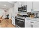 Modern kitchen with stainless steel appliances, white cabinets, and hardwood floors at 850 Grove St, Denver, CO 80204