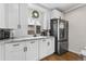 Charming kitchen with white cabinets, modern countertops, and stainless refrigerator at 850 Grove St, Denver, CO 80204