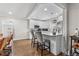 Bright kitchen featuring white cabinets, hardwood floors, and an island with bar seating at 850 Grove St, Denver, CO 80204