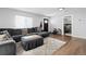 Bright living room with a gray sectional couch and a view of the front door and an adjacent bedroom at 850 Grove St, Denver, CO 80204