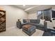 Finished basement with a gray sectional couch and a bookshelf at 6780 Canosa St, Denver, CO 80221