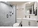 Modern bathroom featuring glass enclosed shower with stylish tile work and a white vanity at 6780 Canosa St, Denver, CO 80221