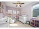 Bedroom with a white crib, rocking chair, and soft decor at 6780 Canosa St, Denver, CO 80221