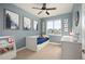 Charming bedroom with blue walls, a full-sized bed with drawers, and decor at 6780 Canosa St, Denver, CO 80221