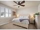 Cozy bedroom with a ceiling fan, comfortable bed, and natural light from the window at 6780 Canosa St, Denver, CO 80221