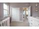 Bedroom with lavender paint, white furniture, and a closet with doors at 6780 Canosa St, Denver, CO 80221