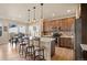 Eat-in kitchen with modern appliances, an island with barstool seating, and stylish pendant lighting at 6780 Canosa St, Denver, CO 80221