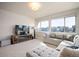 Bright living room with a comfortable sectional couch, entertainment center, and lots of natural light at 6780 Canosa St, Denver, CO 80221