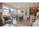 Living and dining rooms featuring wood floors and light gray walls, with lots of natural light at 6780 Canosa St, Denver, CO 80221