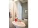 Powder room featuring a sleek pedestal sink, neutral color palette, and stylish towel rack at 1959 Morningview Ln, Castle Rock, CO 80109