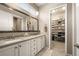 The main bathroom offers double sinks, great lighting, vanity storage, a walk-in closet, and a tiled floor at 3418 New Haven Cir, Castle Rock, CO 80109