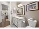 Well-lit bathroom featuring vanity, framed mirror, and close proximity to the kitchen at 3418 New Haven Cir, Castle Rock, CO 80109