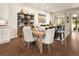 A lovely dining area features hardwood floors, with a wooden table and decorative shelving in a naturally lit open space at 3418 New Haven Cir, Castle Rock, CO 80109
