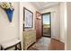 Charming entryway with a decorative console table, a stylish rug, and an open door leading to the outside at 3418 New Haven Cir, Castle Rock, CO 80109