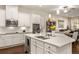 Spacious kitchen featuring white cabinets, stainless steel appliances, and a large island with a sink at 3418 New Haven Cir, Castle Rock, CO 80109