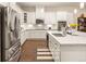 Modern kitchen with white cabinets, stainless steel appliances, and a large island featuring a sink and seating at 3418 New Haven Cir, Castle Rock, CO 80109