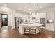 Bright, modern kitchen with white cabinets, stainless steel appliances, and a large island with seating at 3418 New Haven Cir, Castle Rock, CO 80109