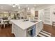 Open-concept kitchen with a large island that has seating, stainless steel appliances, and a view of the living room at 3418 New Haven Cir, Castle Rock, CO 80109